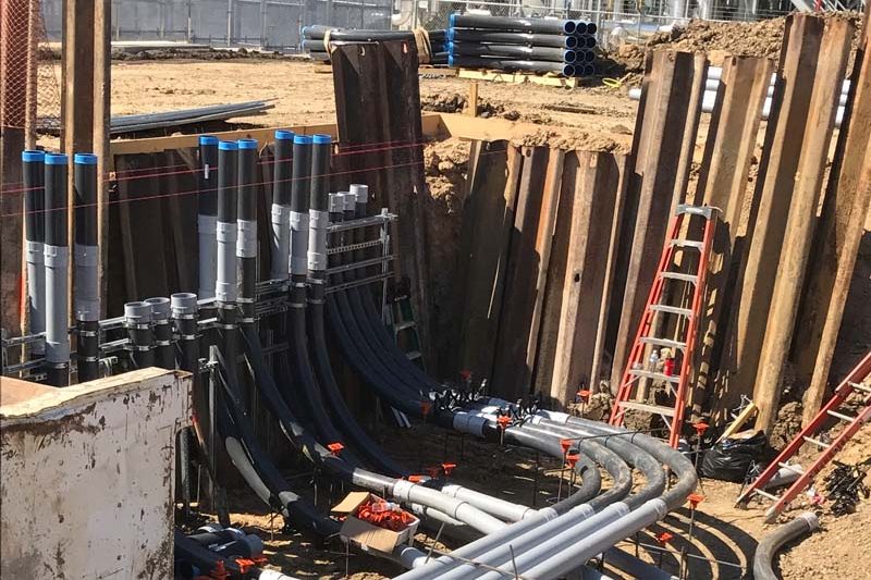 Rows of conduit forming a multi-duct ductbank in a shored trench