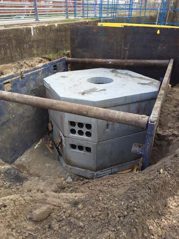 Large precast concrete vault set into a shored excavation
